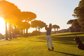 Image showing golf player hitting shot with club