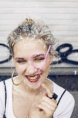 Image showing young pretty party girl smiling covered with glitter tinsel, fashion dress, stylish make up, lifestyle people concept close up