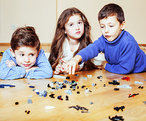 Image showing funny cute children playing lego at home, boys and girl smiling, first education role lifestyle