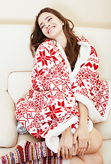 Image showing young pretty brunette girl in Christmas ornament blanket getting