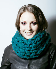 Image showing young pretty real woman in sweater and scarf all over her face s