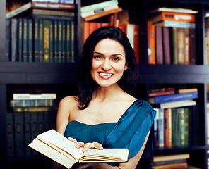 Image showing portrait of beauty young brunette woman reading book in library smiling, muslim girl in education, lifestyle people concept