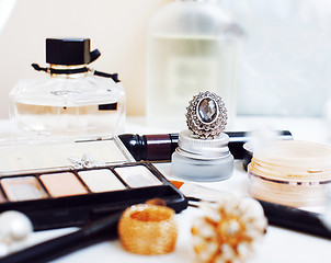 Image showing Jewelry table with lot of girl stuff on it, little mess in cosme