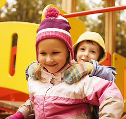 Image showing little cute boy and girl playing outside on playground