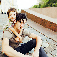 Image showing little son with father in city hagging and smiling, casual look 