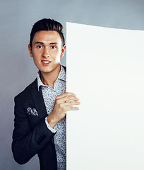 Image showing young pretty business man standing on white background, modern hairstyle, posing emotional, lifestyle people concept