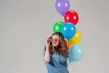 Image showing girl with sunglasses and bunch of colorful balloons