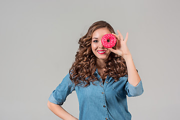 Image showing The smiling girl on gray studio background with round cake
