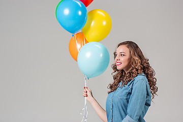 Image showing girl with bunch of colorful balloons