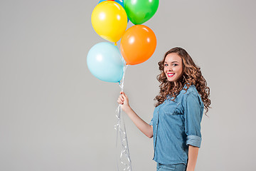 Image showing girl with bunch of colorful balloons