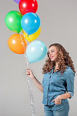 Image showing girl with bunch of colorful balloons