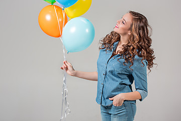 Image showing girl with bunch of colorful balloons