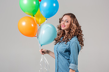 Image showing girl with bunch of colorful balloons