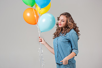 Image showing girl with bunch of colorful balloons