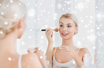 Image showing woman with makeup brush and powder at bathroom