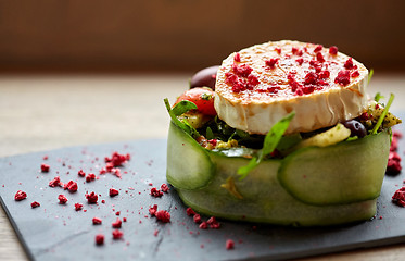 Image showing goat cheese salad with vegetables at restaurant