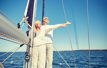 Image showing senior couple enjoying freedom on sail boat in sea