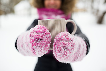 Image showing close up of woman with tea mug outdoors in winter