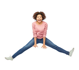 Image showing happy african american woman jumping over white