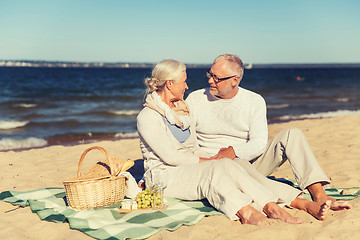 Image showing happy senior couple talking on summer beach