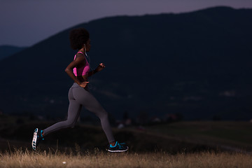 Image showing Young African american woman jogging in nature