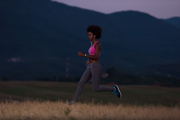 Image showing Young African american woman jogging in nature