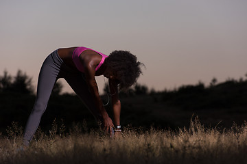 Image showing black woman is doing stretching exercise relaxing and warm up