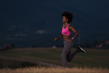 Image showing Young African american woman jogging in nature