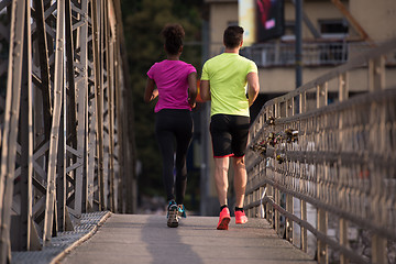 Image showing multiethnic couple jogging in the city