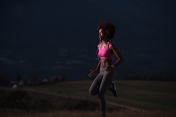 Image showing Young African american woman jogging in nature