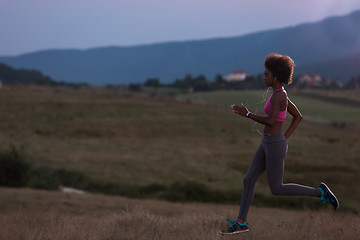 Image showing Young African american woman jogging in nature