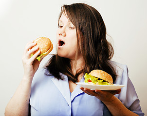 Image showing fat white woman having choice between hamburger and salad close 