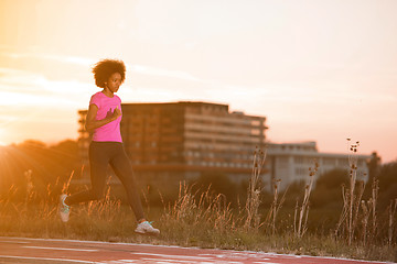 Image showing a young African American woman jogging outdoors