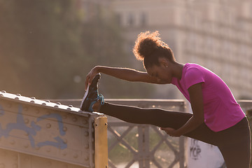 Image showing African American woman doing warming up and stretching