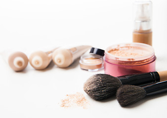 Image showing Powder, foundation and brushes on the white background