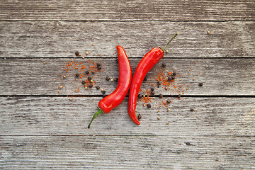 Image showing Red hot chili peppers on wood