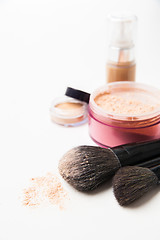 Image showing Powder, foundation and brushes on the white background