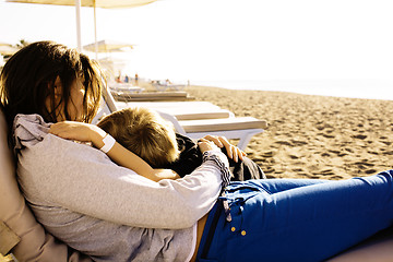 Image showing young mother with son resting on sea coast, happy family together talking, lifestyle people concept