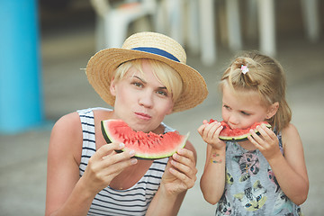 Image showing Mother And Daughter Enjoying Slices Of WaterMelon