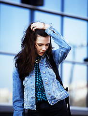 Image showing young pretty girl near business building walking