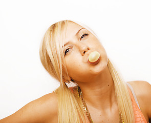 Image showing pretty blond woman blowing gum bubbles isolated on white background, lifestyle people concept