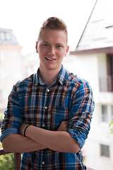 Image showing man standing at balcony