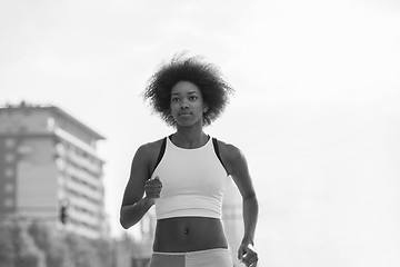 Image showing Portrait of sporty young african american woman running outdoors