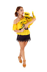 Image showing Beautiful woman standing with sunflowers.