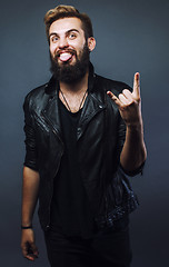 Image showing young attractive bearded hipster man gesturing emotional screami