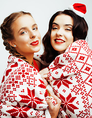 Image showing young pretty happy smiling blond and brunette woman girlfriends on christmas in santas red hat and holiday decorated plaid, lifestyle people concept