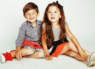 Image showing little cute boy and girl hugging playing on white background, ha