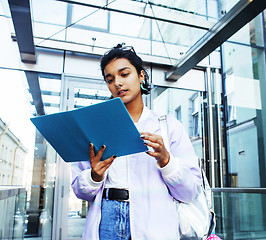 Image showing young cute indian girl at university building sitting on stairs