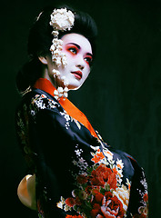 Image showing geisha in kimono on black