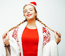 Image showing young pretty happy smiling blond woman on christmas in santas red hat and holiday decorated plaid, lifestyle people concept